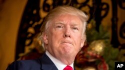 FILE - President-elect Donald Trump takes a question from a member of the media at Mar-a-Lago, in Palm Beach, Florida.