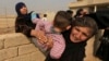 Civilians flee their houses, as Iraq's elite counterterrorism forces fight against Islamic State militants, in the village of Tob Zawa, about 9 kilometers (5.6 miles) from Mosul, Iraq, Oct. 25, 2016. 