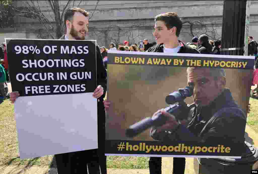 Anti-gun control protesters hold signs at the "March for Our Lives" rally in Washington, March 24, 2018. (G. Tobias/VOA)