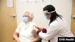 A woman gets a coronavirus vaccine at a CVS pharmacy, which has started a sweepstakes campaign for people who sign up for the vaccine. (Photo courtesy of CVS) 