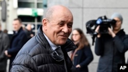 FILE - French Foreign Minister Jean-Yves Le Drian speaks with journalists as he arrives for a meeting to discuss the situation in Libya at the EEAS building in Brussels, Jan. 7, 2020. 