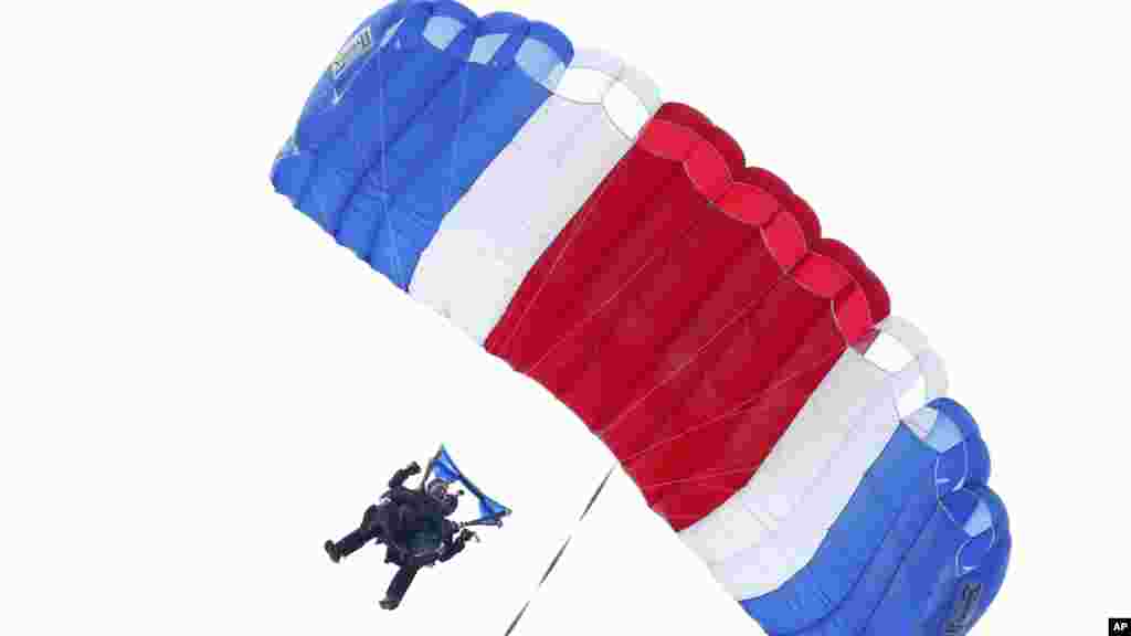 L'ancien président George H. W. Bush, attaché à Sgt. 1er classe Mike Elliott, un membre retraité de l'équipe de parachute Golden Knights de l'armée, lors d'un saut en parachute près de la maison d'été de Bush à Kennebunkport, dans le Maine, le jeudi 12 Juin 2014.