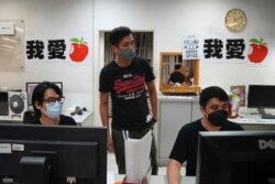 Staff members design the layout for the last edition of Apple Daily at the newspaper's headquarters in Hong Kong, June 23, 2021.