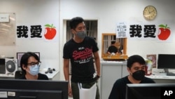 Staff members design their layout for the last edition of newspaper in the Apple Daily headquarters in Hong Kong, June 23, 2021.
