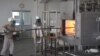 Cambodian workers at Nikko-Kinzokou's factory at the Phnom Penh Special Economic Zone feed molds into a furnace. The factory produces heat-resistant stainless steel baskets to hold and transport auto-parts. (D. de Carteret/VOA)