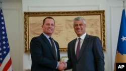 Kosovo President Hashim Thaci, right, shakes hands with President Donald Trump's envoy for the Kosovo-Serbia dialogue, Ambassador Richard Grenell, in Kosovo's capital of Pristina, Oct. 9, 2019.