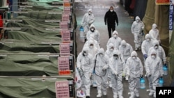 Market workers wearing protective gear spray disinfectant at a market in the southeastern city of Daegu on February 23, 2020 as a preventive measure after the COVID-19 coronavirus outbreak.