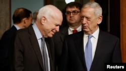 Committee chairman U.S. Senator John McCain, left, welcomes retired U.S. Marine Corps General James Mattis to testify before a Senate Armed Services Committee hearing on his nomination to serve as defense secretary in Washington, Jan. 12, 2017.