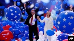 Democratic vice presidential nominee Tim Kaine and Democratic presidential nominee Hillary Clinton walk through the falling balloons during the final day of the Democratic National Convention in Philadelphia, July 28, 2016.