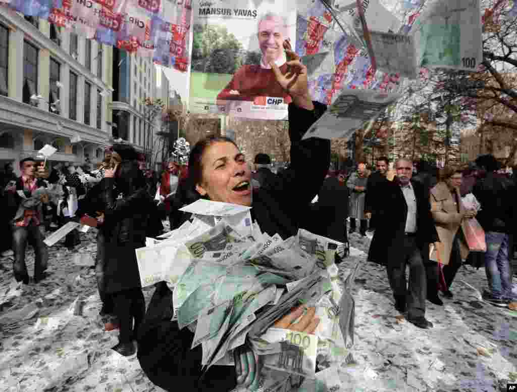Members of the main opposition Republican People's Party throw fake Euro bills into the air during an anti-government protest denouncing a corruption scandal that has shaken Prime Minister Recep Tayyip Erdogan’s government, in Ankara, Turkey.