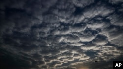 Sun sets behind a patterned cloud formed over the city in Kolkata, West Bengal state, India, Monday, May 18, 2020. A cyclonic storm 'Amphan' has intensified into a super cyclone over the Bay of Bengal and expected a landfall near Sundarbans, south…