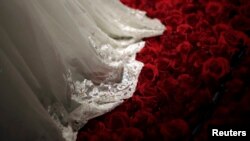 FILE PHOTO - A wedding dress is displayed during a group wedding ceremony hosted by the French Pavilion at the Shanghai World Expo May 11, 2010.REUTERS/Aly Song