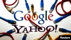 FILE - An illustration shows the logos of Google and Yahoo connected with LAN cables in a Berlin office in Germany, Oct. 31, 2013.