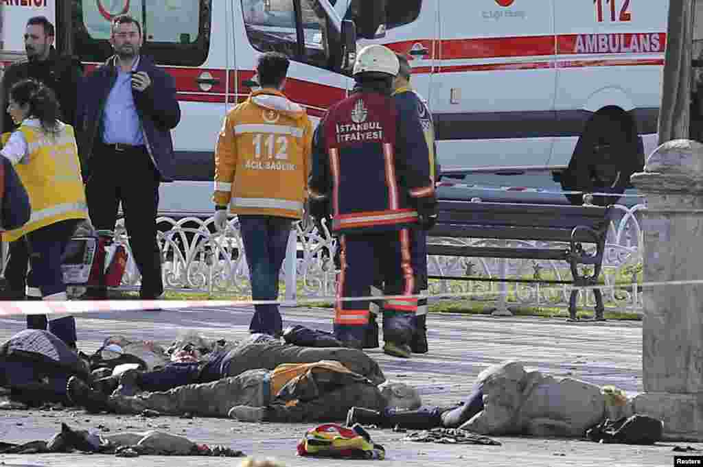 Rescue teams gather at the scene next to bodies after an explosion in the heart of Istanbul's historic Sultanahmet tourist district, in central Istanbul, Jan. 12, 2016.