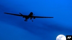 FILE - In this Jan. 31, 2010, photo, an unmanned U.S. Predator drone flies over Kandahar Air Field, southern Afghanistan, on a moonlit night.