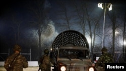 FILE - A vehicle with a fan to move away tear gas is seen near Turkey's Pazarkule border crossing, in Kastanies, Greece, March 12, 2020.