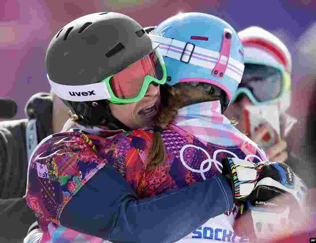 Russia's Vic Wild (left) celebrates after winning the gold medal in the men's snowboard parallel giant slalom final, with his wife and bronze medalist in the women's snowboard parallel giant slalom final, Russia's Alena Zavarzina, Krasnaya Polyana, Russia, Feb. 19, 2014.