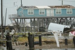 Flooding surrounds damaged homes Aug. 28, 2020, in Cameron, La., after Hurricane Laura moved through the area Thursday.