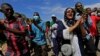 Sudanese protesters march in a demonstration to mark the anniversary of a transitional power-sharing deal with demands for quicker political reforms in Khartoum, Sudan, Aug. 17, 2020.