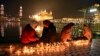 Sejumlah umat Sikh menyalakan lilin di Kuil Emas di Amritsar, India, 30 November 2020. 
