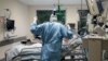 An intubated COVID-19 patient gets treatment at the intensive care unit at the Westerstede Clinical Center, a military-civilian hospital in Westerstede, northwest Germany, Dec. 17, 2021. 