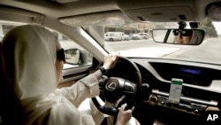 In this Sunday, June 24, 2018 photo, Ammal Farahat, who has signed up to be a driver for Careem, a regional ride-hailing service that is a competitor to Uber, drives her car in Riyadh, Saudi Arabia. After lifting a longstanding ban on women driving, it's the latest job opening for Saudi women, that had been reserved for men only, and one that sharply challenges traditional norms. (AP Photo/Nariman El-Mofty)