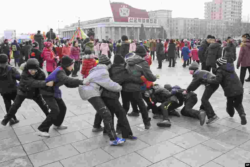 North Korean boys play "catch the tail" as they gather at Kim Il Sung Square for Lunar New Year in Pyongyang.