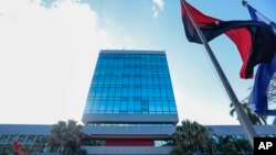 A Sandinista National Liberation Front ruling party banner and a national flag fly outside the Social Security Institute, in Managua, Nicaragua, Feb. 8, 2019.