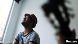 Venezuelan mVenezuelan migrant Alexander Beja sings after an interview with Reuters in Soacha, Colombia, Aug. 23, 2019.igrant Alexander Beja sings after an interview with Reuters in Soacha, Colombia, Aug. 23, 2019.