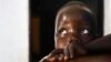 In this photo taken Friday, April 27, 2012, in Gulu, Uganda, Betty, 3, looks up at her mother Adye Sunday, 25, unseen, who was abducted when she was 13 by Lord's Resistance Army leader Joseph Kony and forced to be one of his dozens of "wives." She says he's also the father of her two children 