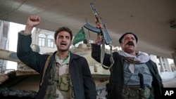 Houthi Shiite fighters chant slogans as they guard a street leading to the residence of former Yemeni President Ali Abdullah Saleh, in Sanaa, Yemen, Dec. 4, 2017. 
