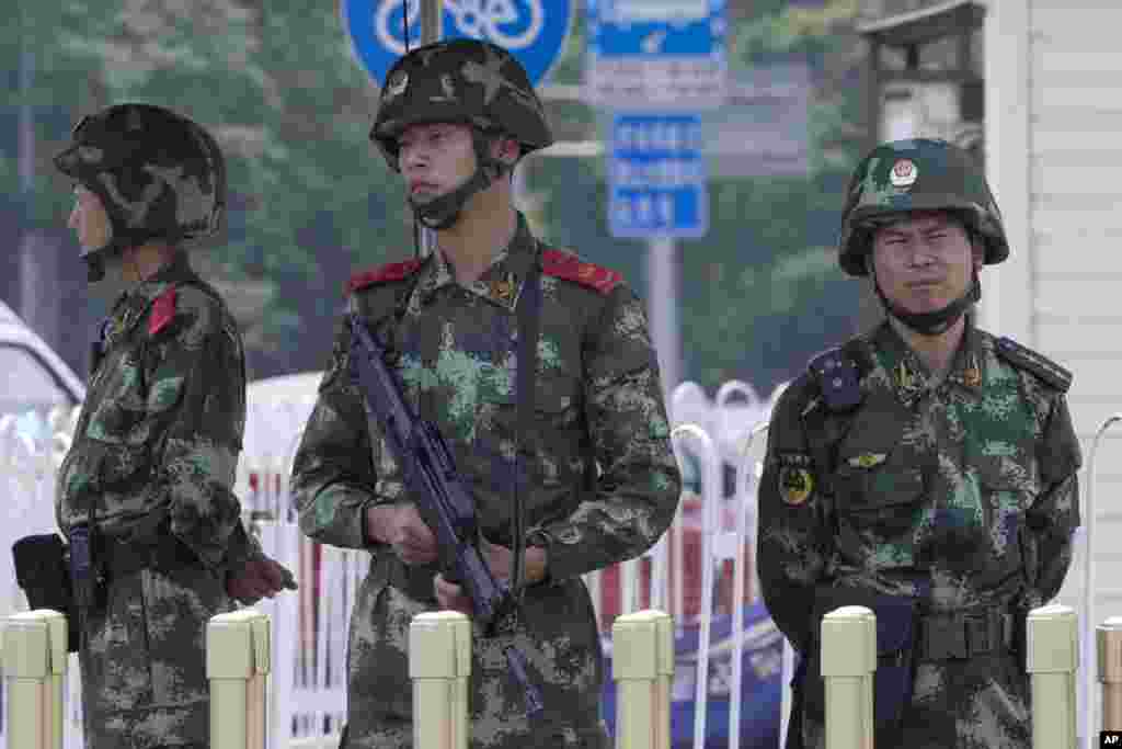 Chinese paramilitary policemen man a security checkpoint on Tiananmen Square in Beijing, June 4, 2014.