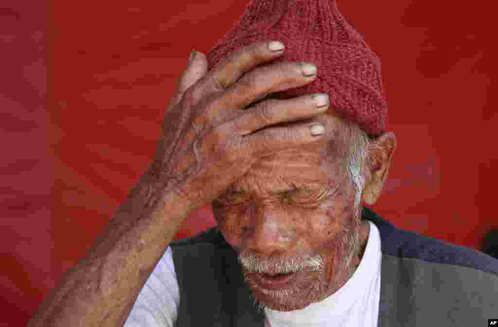 Funchu Tamang, who believes himself to be 101 years old, recounts how he suffered injuries in the recent earthquake, though he believes that he is fortunate to be alive, in the village of Kimtang, May 4, 2015. 
