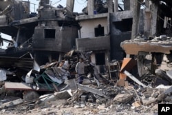 A Palestinian looks at the destruction left by an Israeli bombardment in the Maghazi refugee camp, central Gaza Strip, on Feb. 16, 2024.