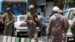 FILE - Members of the Iranian Revolutionary Guard are seen in Tehran, June 7, 2017. Two high-ranking commanders of the Iranian Revolutionary Guard Corps (IRGC) reportedly have been killed in Syria.