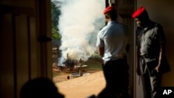 FILE - Officials watch from a distance as a pile of some 2,000 illegally trafficked elephant tusks and hundreds of finished ivory products are destroyed in the first ever Cameroonian burn of poached wildlife goods, in Yaounde, Cameroon, April 19, 2016. Cameroon has deployed more troops to protect wildlife after poachers killed two forest rangers in the southeastern part of the country. 