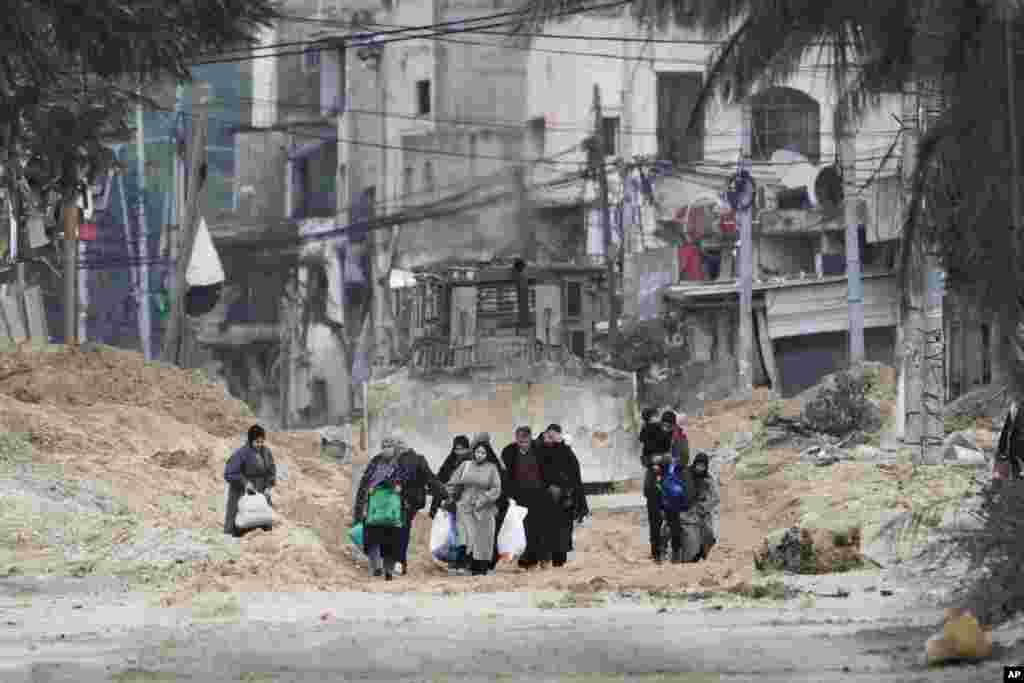 Residents of the West Bank refugee camp of Nur Shams, Tulkarem, evacuate their homes as the Israeli military continues its operation in the area. (AP Photo/Majdi Mohammed)