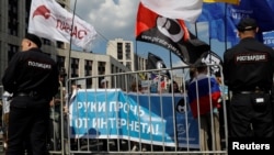 FILE - People hold a banner reading "Hands off the internet" during a rally against court decision to block the Telegram messenger because it violated Russian regulations, in Moscow, May 13, 2018.