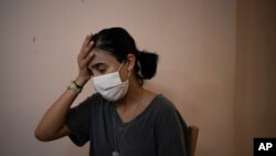 Rachelle Boumelhem reacts during an interview in her damaged beauty salon in Beirut, Lebanon, Aug. 10, 2020.