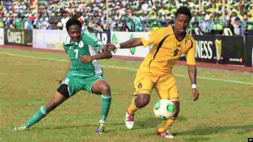 Nigeria's Musa Ahmed, left, is challenged by Ethiopia's Alula Girma, right, during their 2014 World Cup qualifying playoff match.