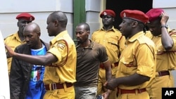 Des policiers encadrent des prévenus lors d'un procès à la haute cour ougandaise, à Kampala, Ouganda, 16 septembre 2011.