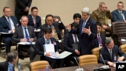 U.S. Secretary of State John Kerry, center right, arrives for a round table meeting of Resolute Support at NATO headquarters in Brussels, Dec. 1, 2015.