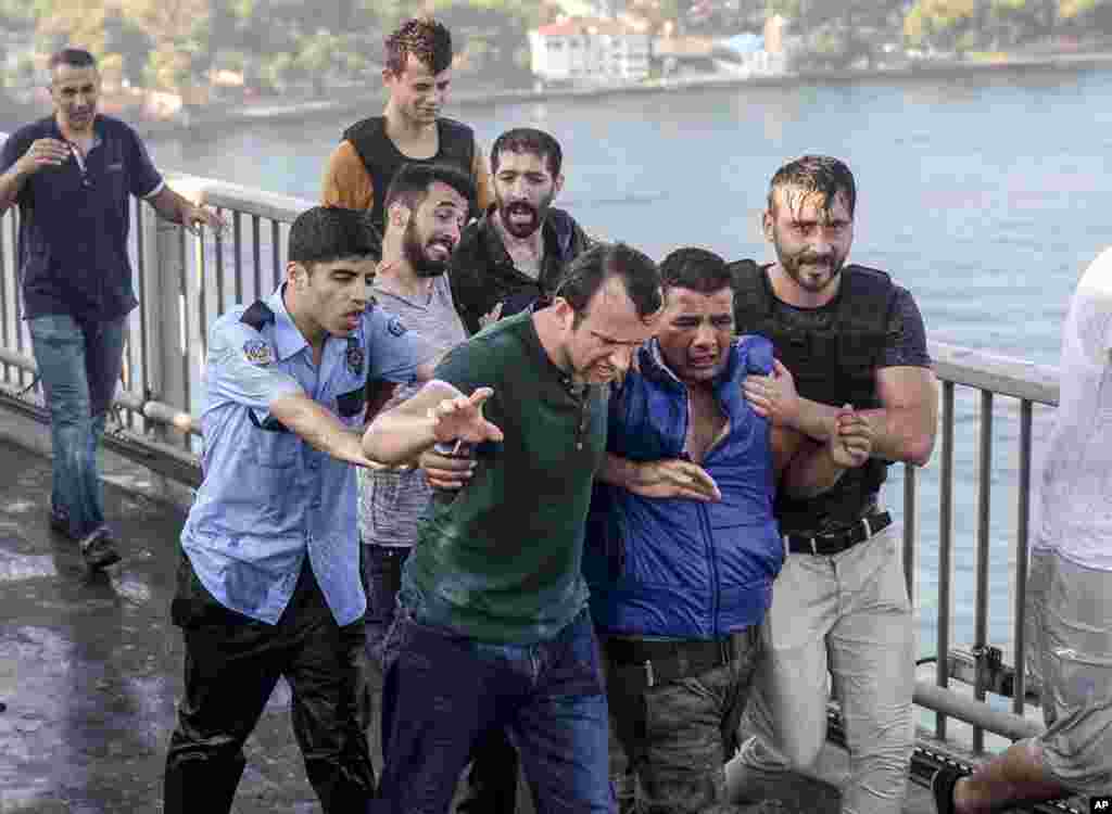 People apprehend a Turkish soldier, who participated in the attempted coup, on Istanbul's Bosporus Bridge, July 16, 2016.