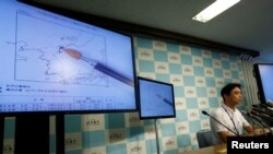 FILE - Japan Meteorological Agency's earthquake and tsunami observations division director Gen Aoki speaks next to screens showing the seismic event was indicated on North Korea, during a news conference, Sept. 9, 2016.
