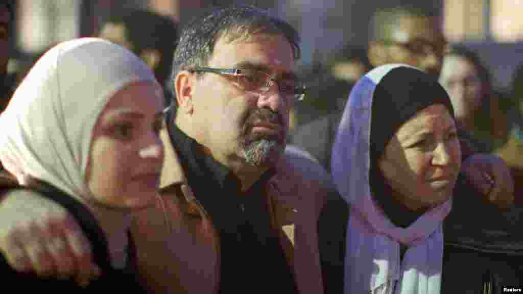 Namee Barakat with his wife, Layla, right, and daughter Suzanne, family of shooting victim Deah Shaddy Barakat, attend a vigil on the campus of the University of North Carolina in Chapel Hill, N.C., Feb. 11, 2015.