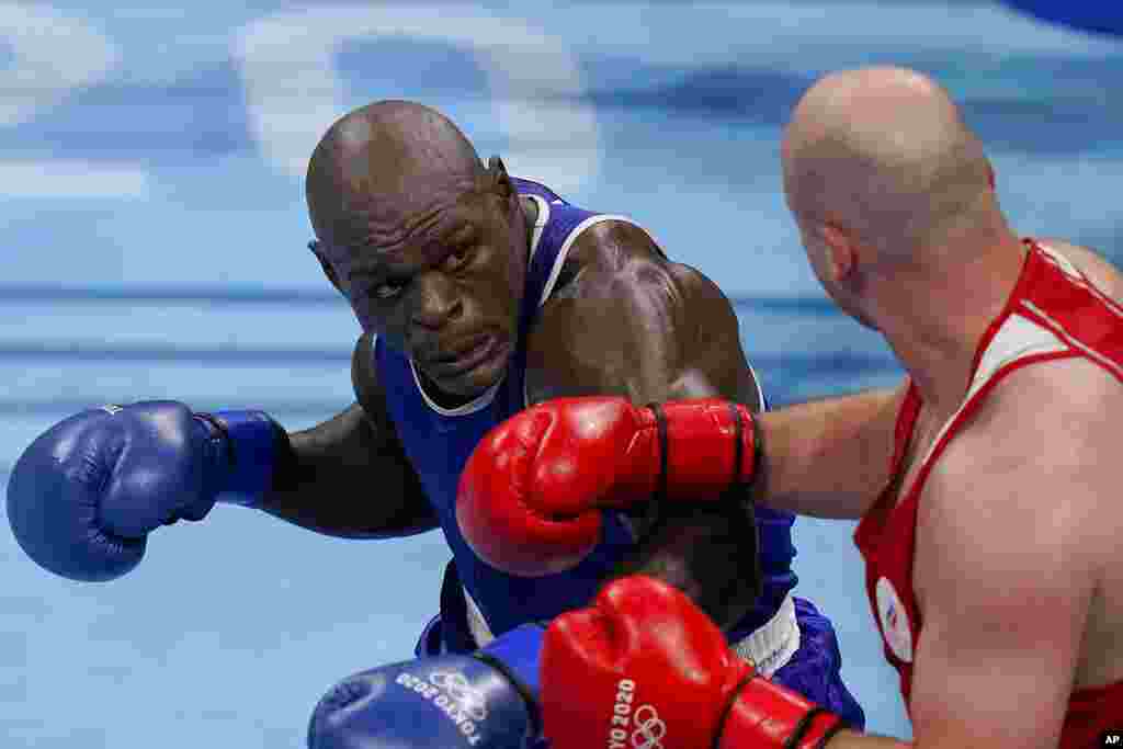 Ivan Veriasov, of the Russina Olympic Committee, right, exchanges punches with Cameroon's Maxime Yegnong Njieyo during their men's super heavyweight over 91-kg boxing match at the 2020 Summer Olympics, Thursday, July 29, 2021, in Tokyo, Japan. (AP Photo/Frank Franklin II)