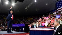 President Donald Trump waves to the crowd as he arrives to speak at a rally in Johnson City, Tenn., Oct. 1, 2018.