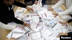 Election Commission officials count votes after presidential and parliamentary elections at a polling station in a school in Zenica, Bosnia and Herzegovina Oct. 7, 2018.