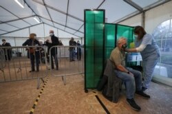 A person receives the Oxford/AstraZeneca coronavirus vaccine at an NHS vaccination center in York, Britain, Jan. 22, 2021.