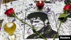 FILE - A makeshift memorial is seen as fans gather at Harlem's Apollo Theater to celebrate the life of deceased musician Prince.